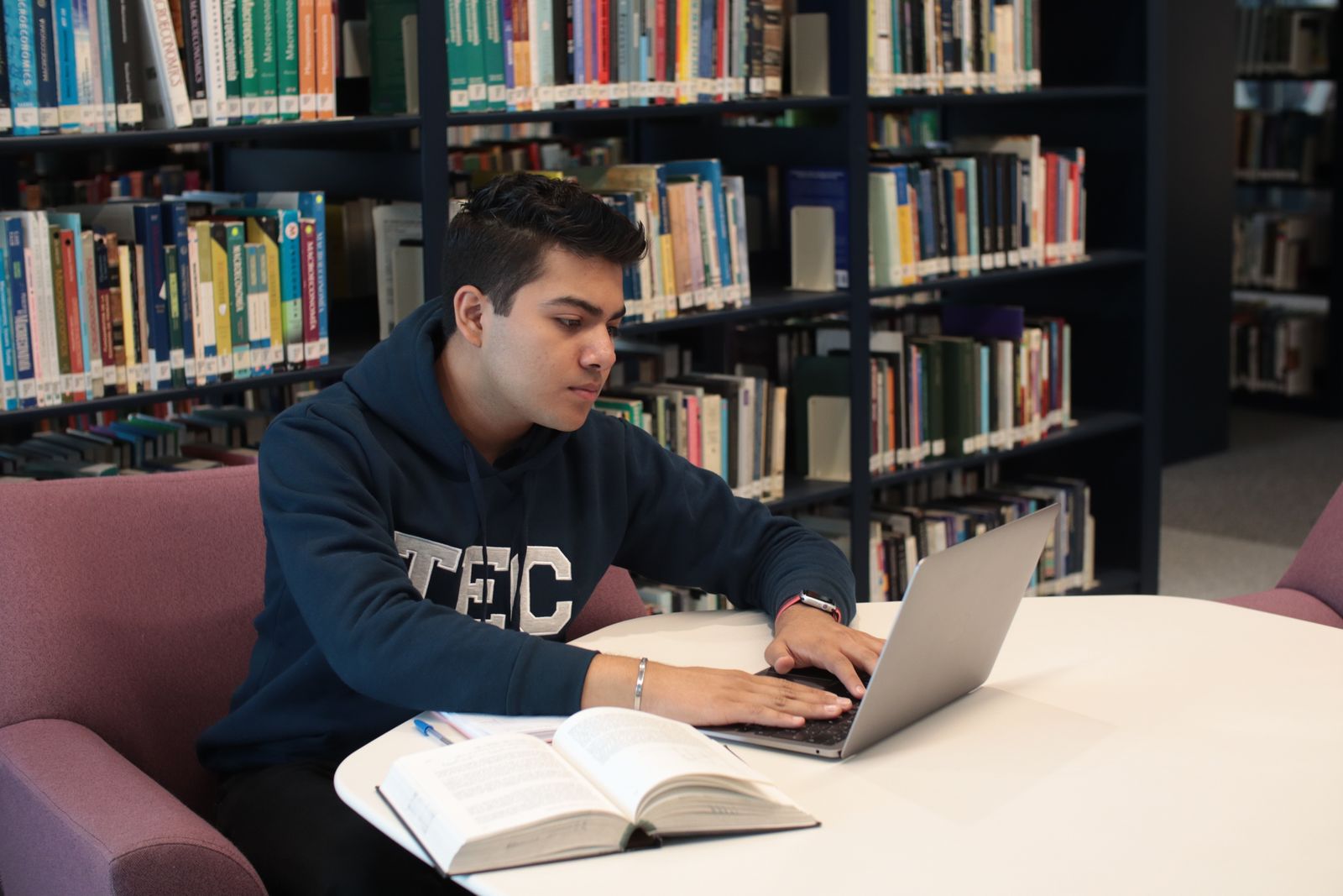 Student working with a laptop in a campus study space